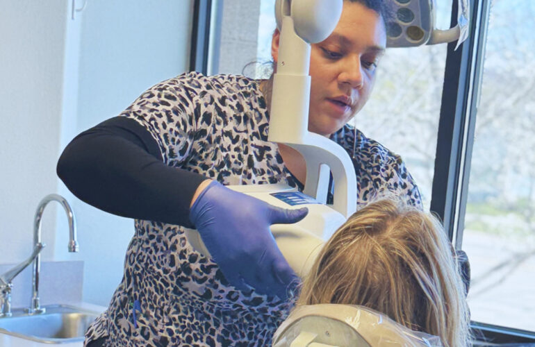 Dental professional taking a patient's digital dental X-ray during a preventive care appointment