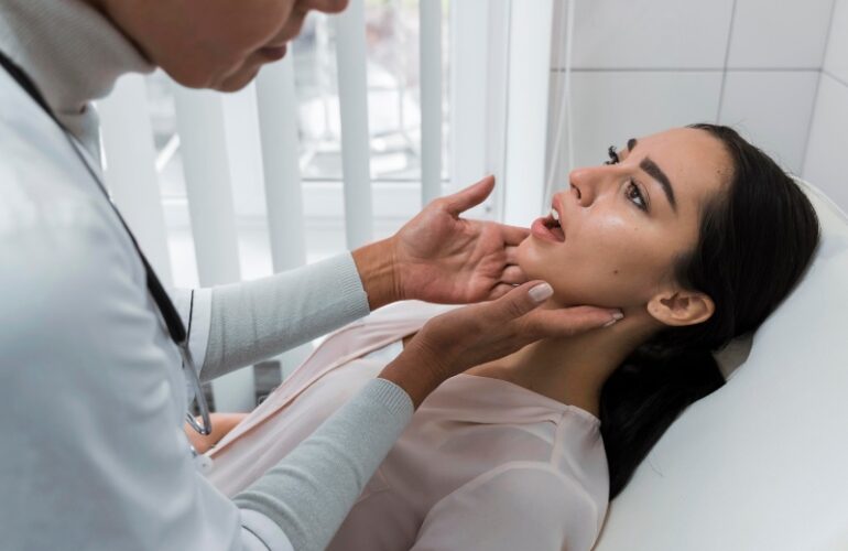 A dentist checking a female dental patient during an oral exam