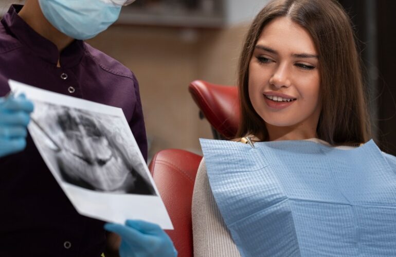 Dentist reviewing dental X-ray with patient