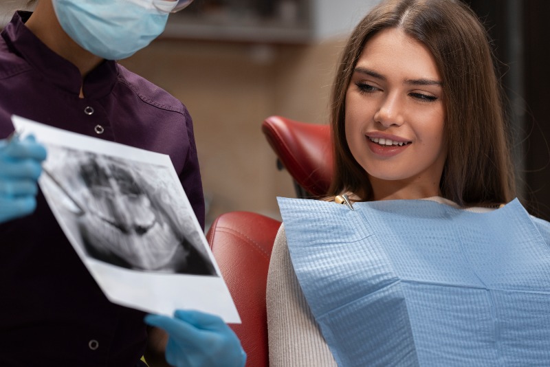 Dentist reviewing dental X-ray with patient