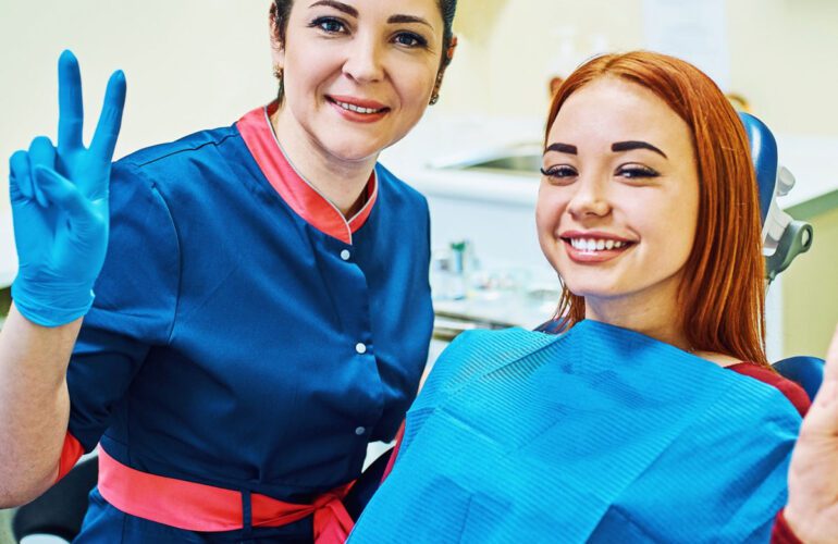 Dentist with smiling patient during a tongue tie and airway treatment consultation in Longmont, CO.