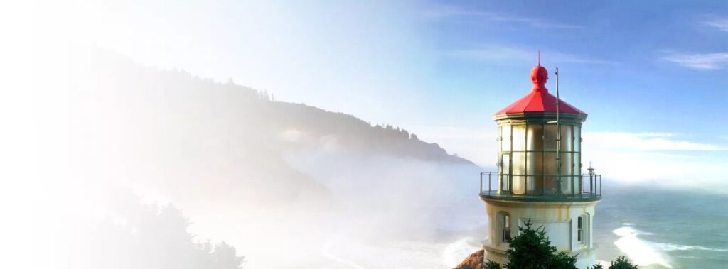 Historic lighthouse on a misty coastline, the Dental Horizons brand symbol of guidance