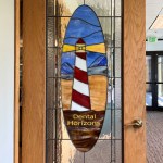 Dental Horizons stained-glass lighthouse sign at the office entrance